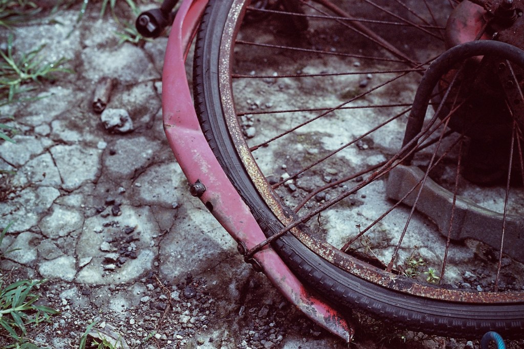 Broken bicycle wheel on stones